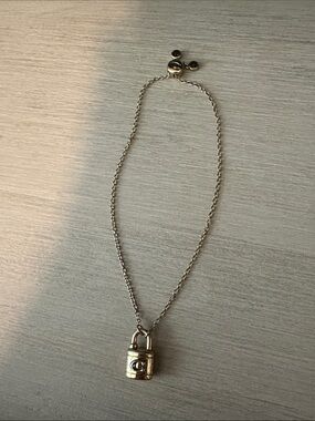 Coach gold padlock tennis bracelet
